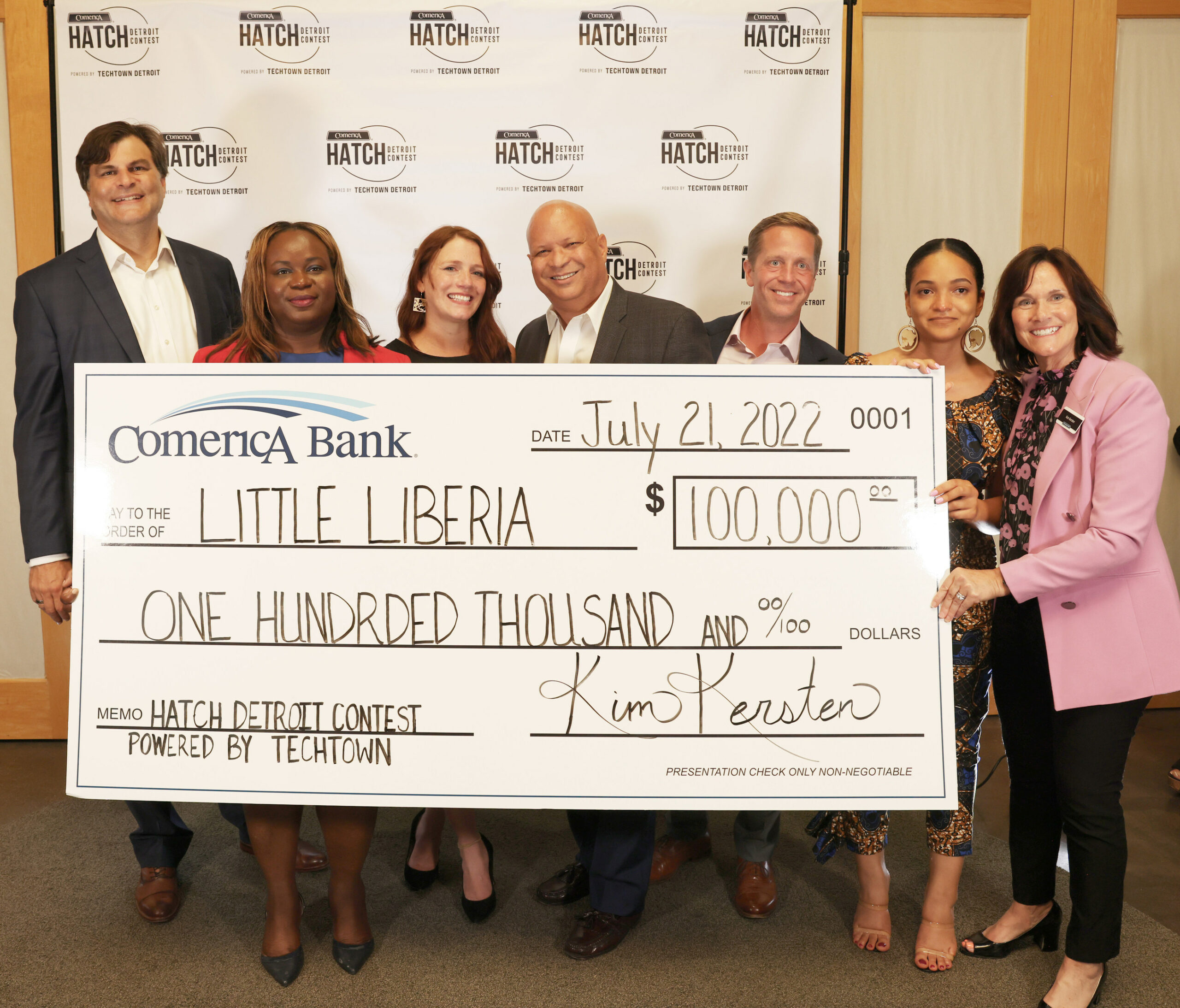 Little Liberia holding a big check!